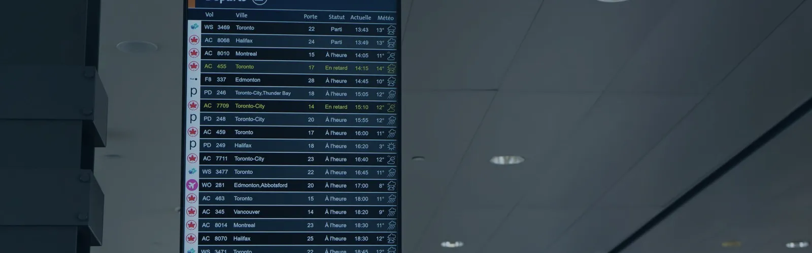Airport departures screen listing Canadian cities